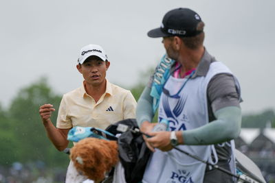 Collin Morikawa with his caddie JJ