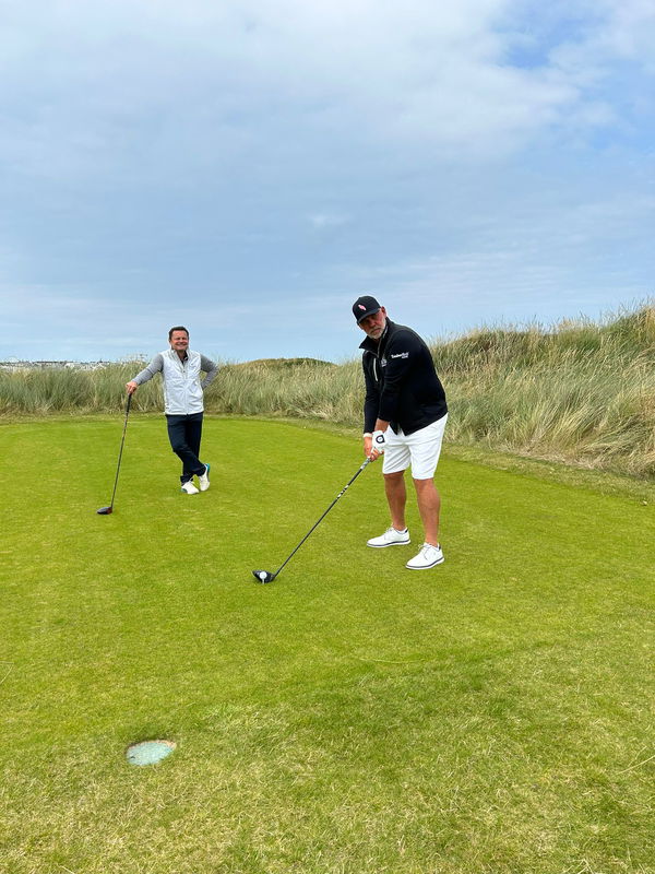 Chris Hollins watches Darren Clarke 