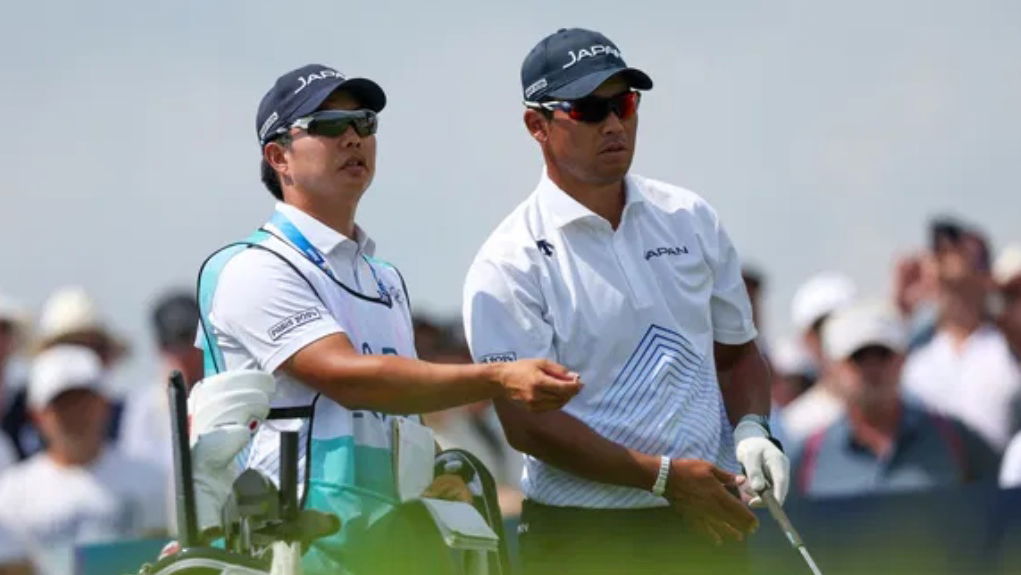 Hideki Matsuyama with his caddie