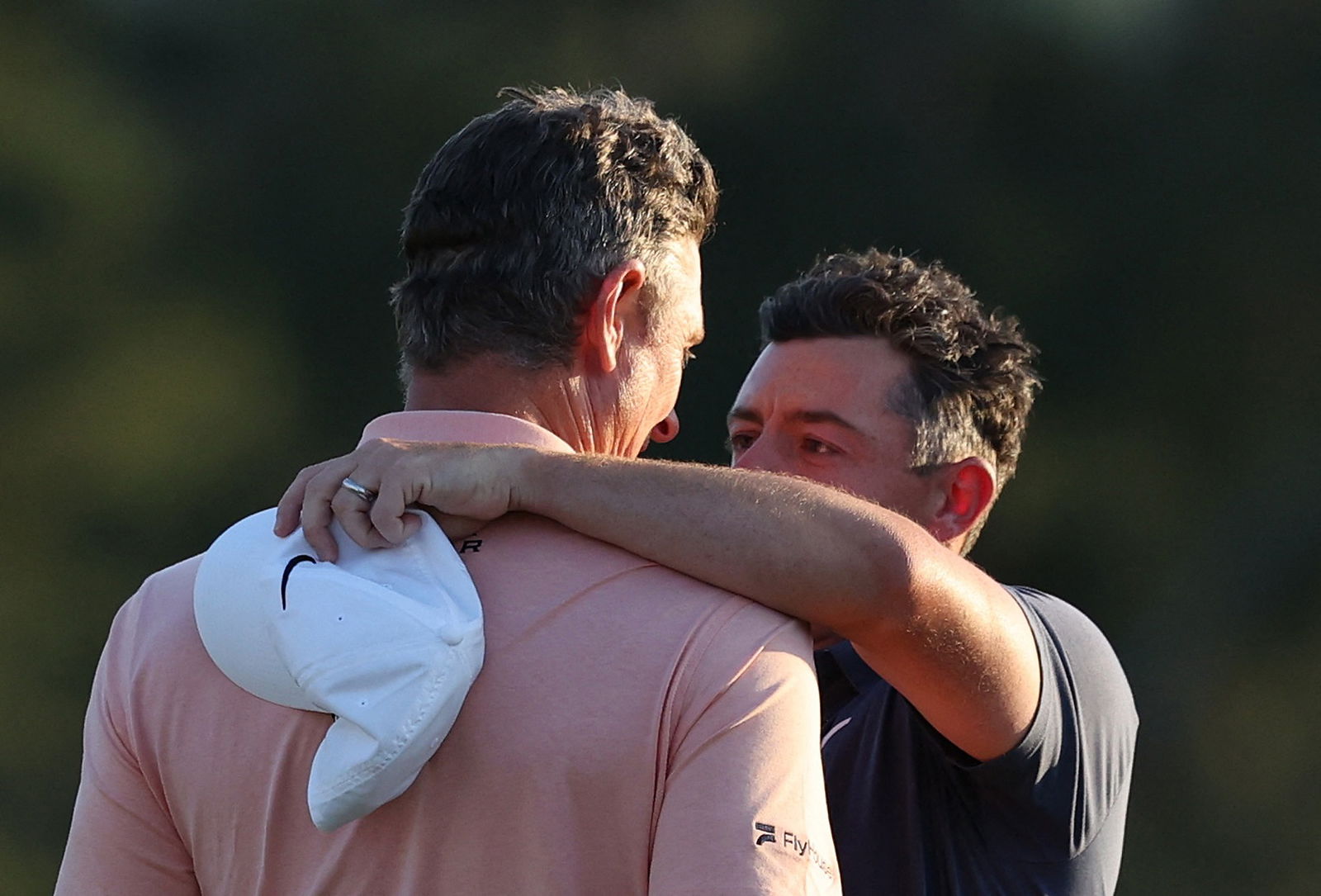 Rose and McIlroy embrace on 18 