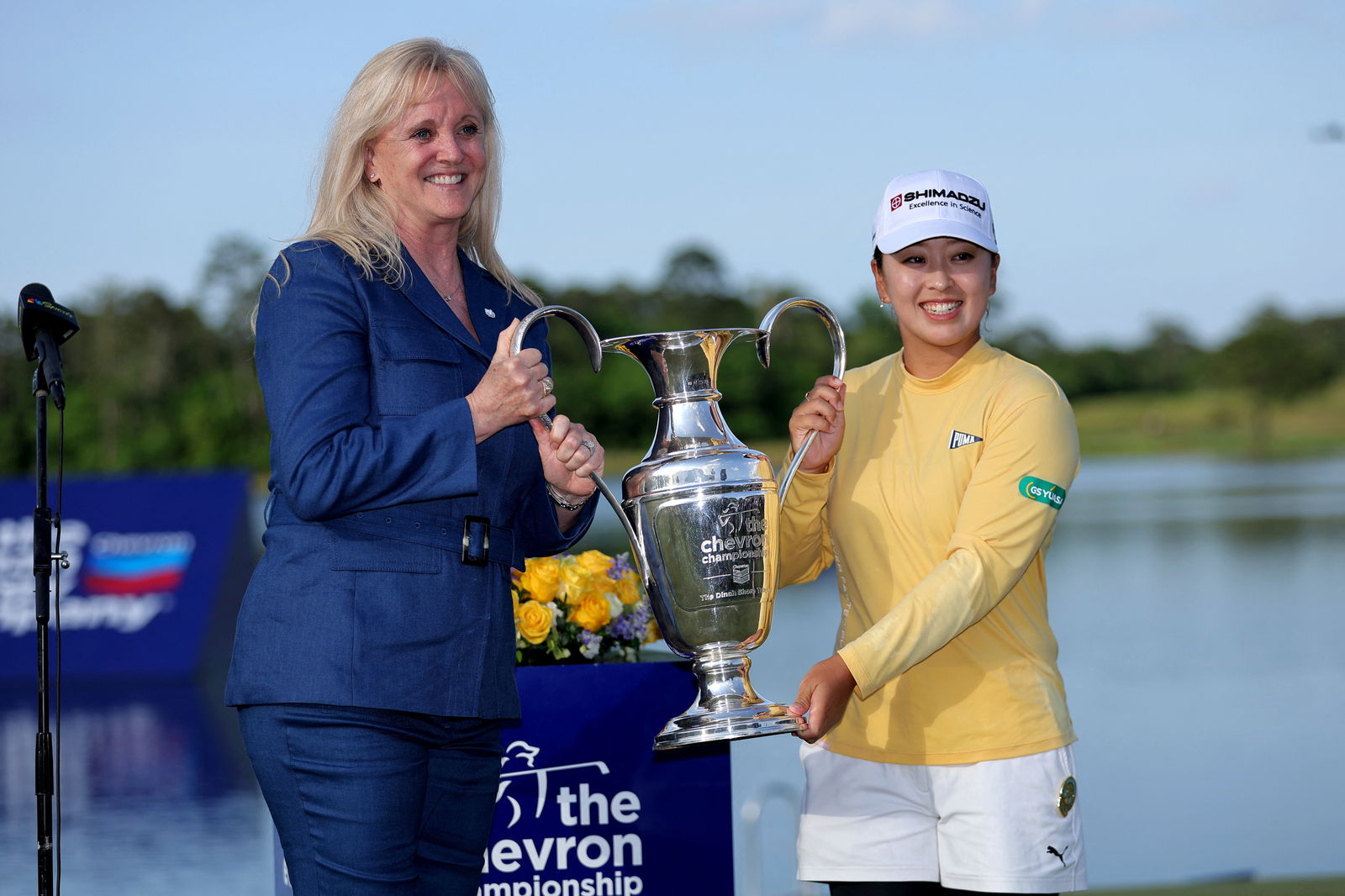 Mao Saigo of Japan is presented with the championship trophy