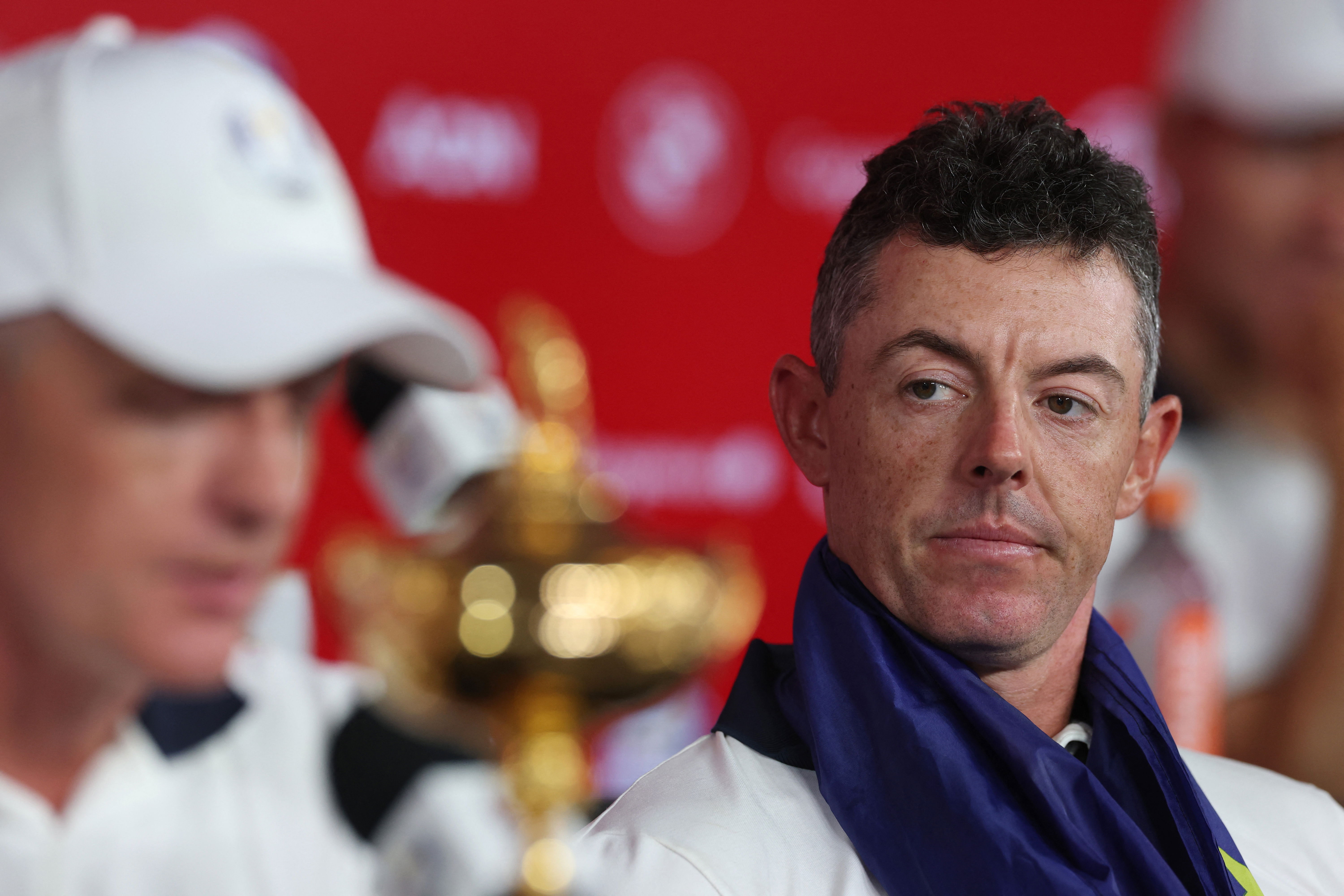 Rory McIlroy listens to Luke Donald