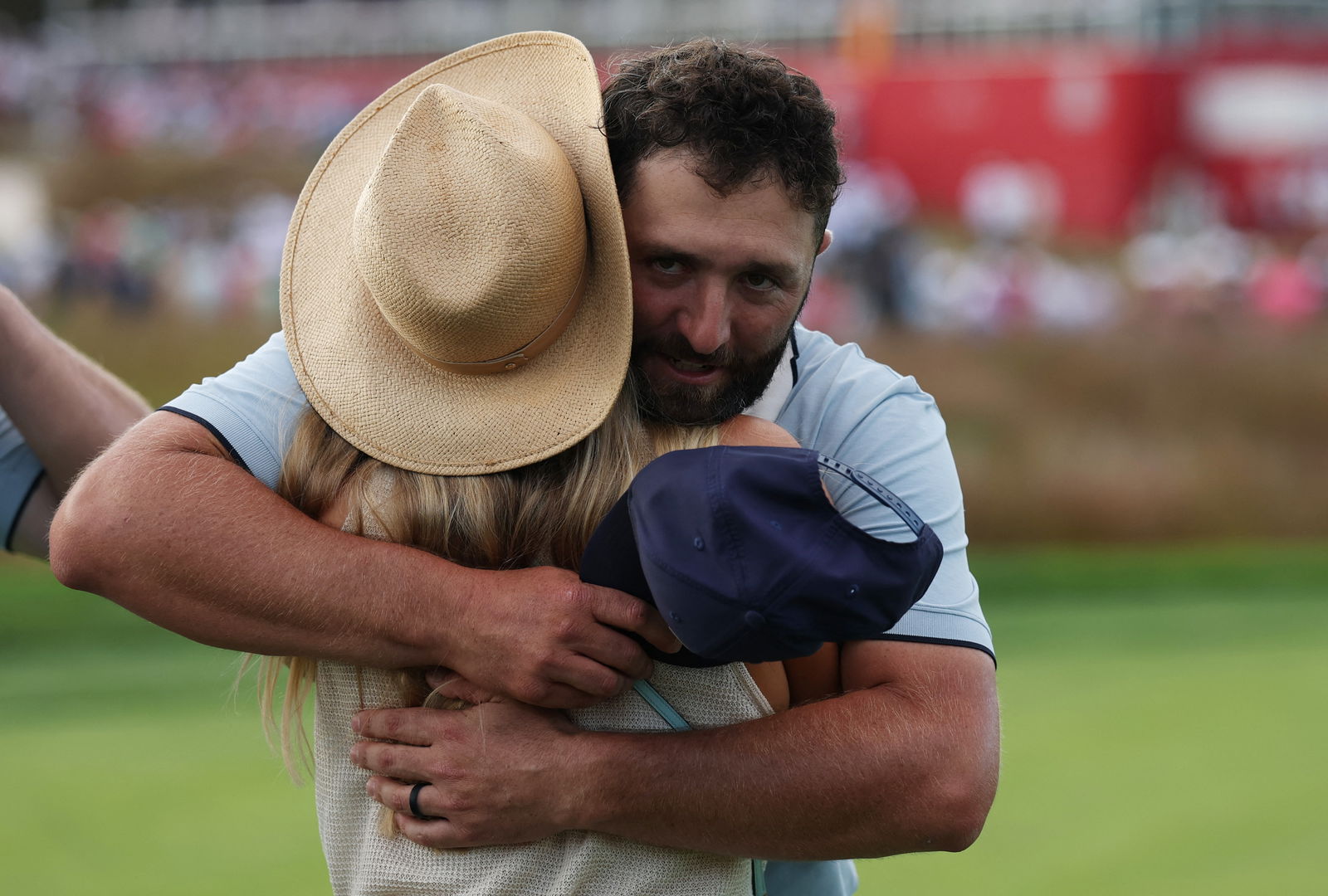 Jon Rahm hugs his wife Kelley
