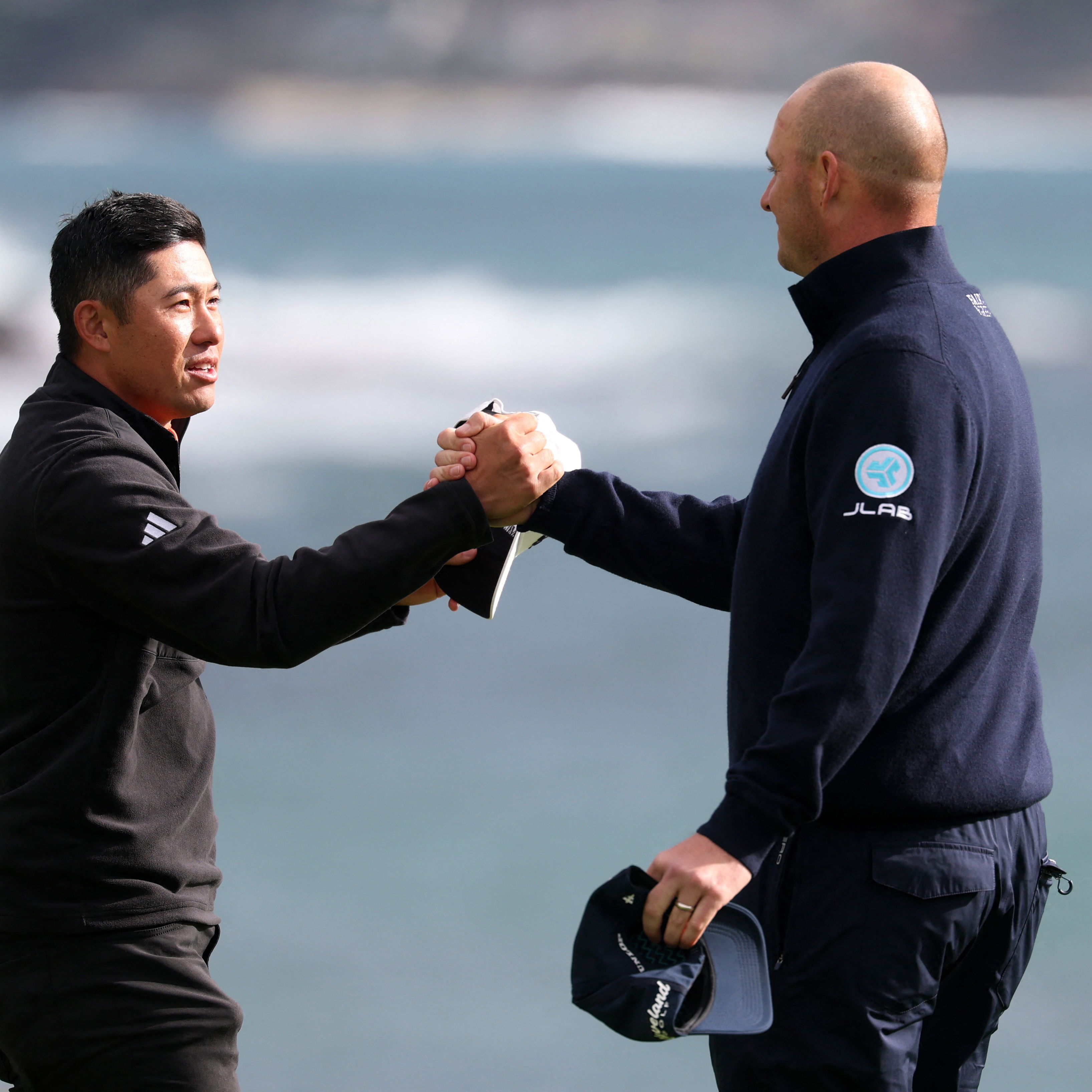 Morikawa and Straka on the 18th green