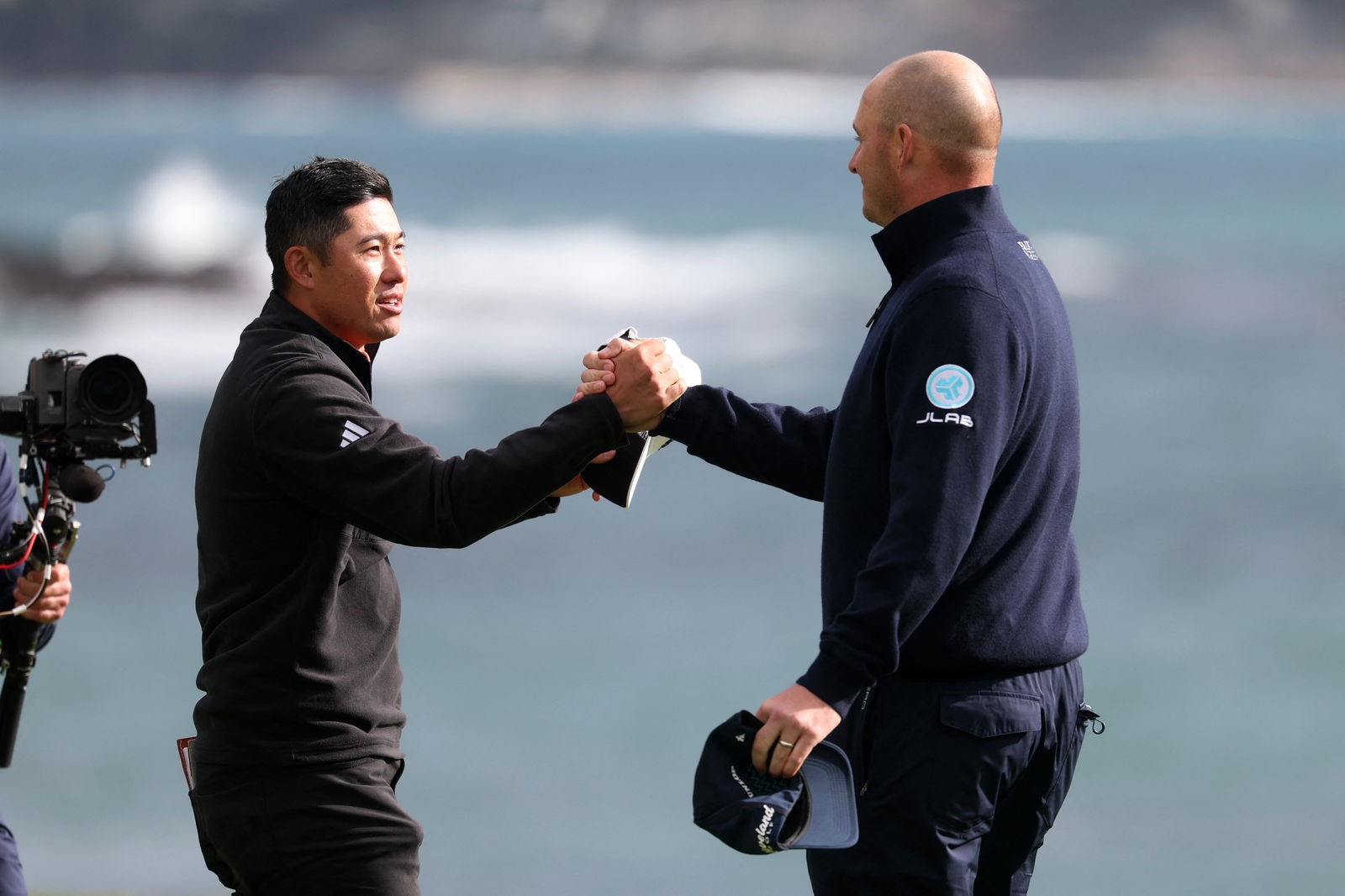 Morikawa and Straka on the 18th green