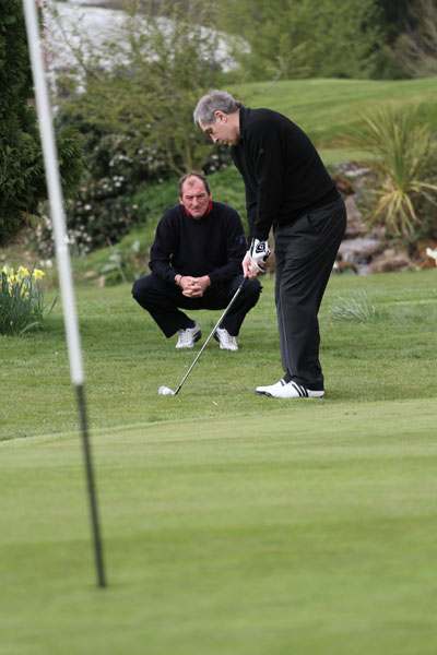 Shilton chips with an 8-iron under the expert eye of mark Mouland
