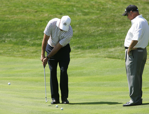Mickelson practises his chipping with coach Butch Harmon