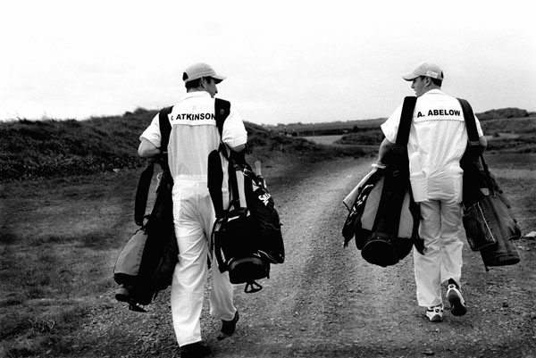 Two Doonbeg caddies carrying double bags-head to the practice ground (All images by Paul Marshall)
