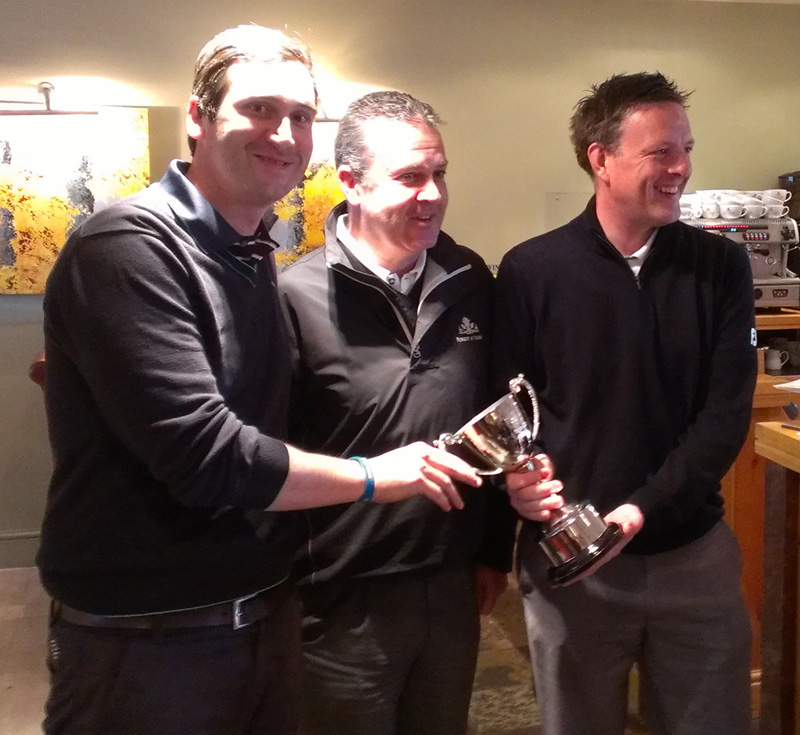 The winners accept their trophy from director of golf Iain Burns