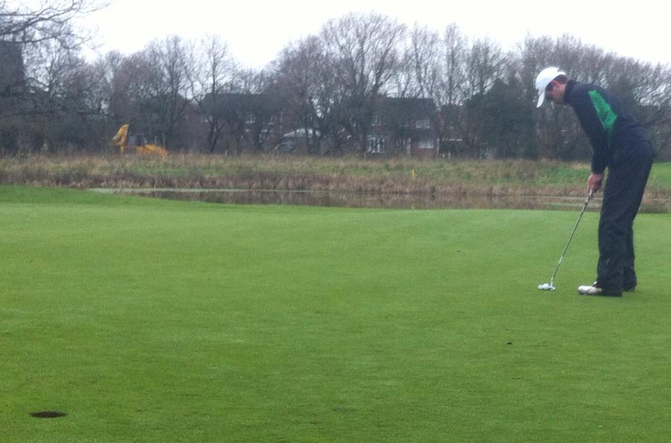 Andy putts for birdie