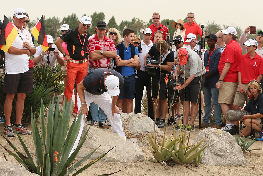 Martin Kaymer inspects his ball after driving into trouble at the ninth (Getty Images)