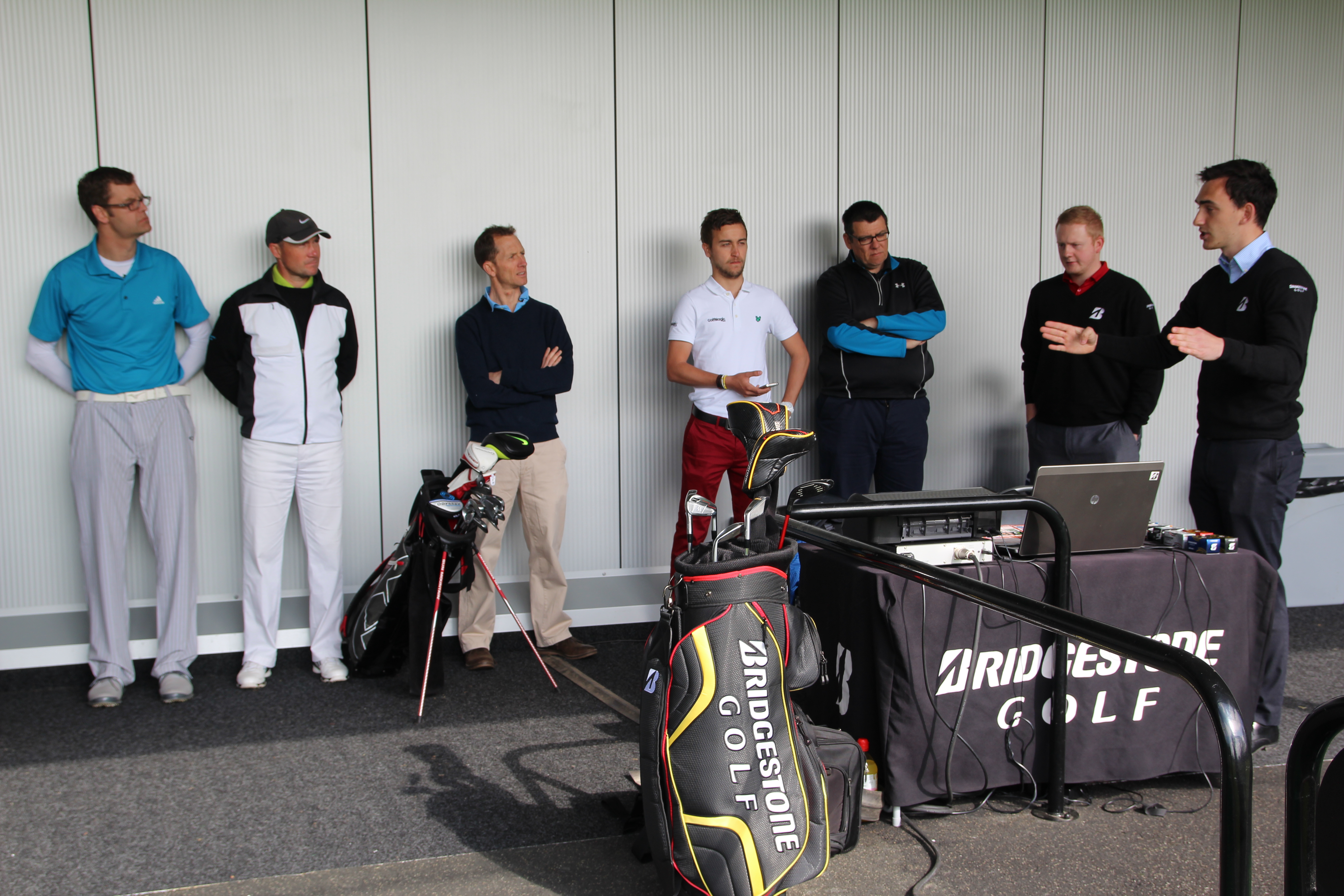 GolfMagic reader Tom Frogley (far left) listens attentively to Bridgestone's Danny Osborne