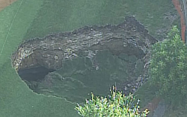 The sinkhole appeared after heavy rain (Photo: KCTV5)