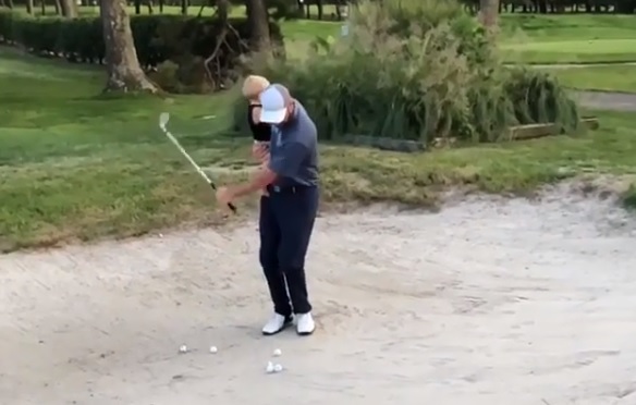 WATCH: Dad shows how to golf and parent at the same time!