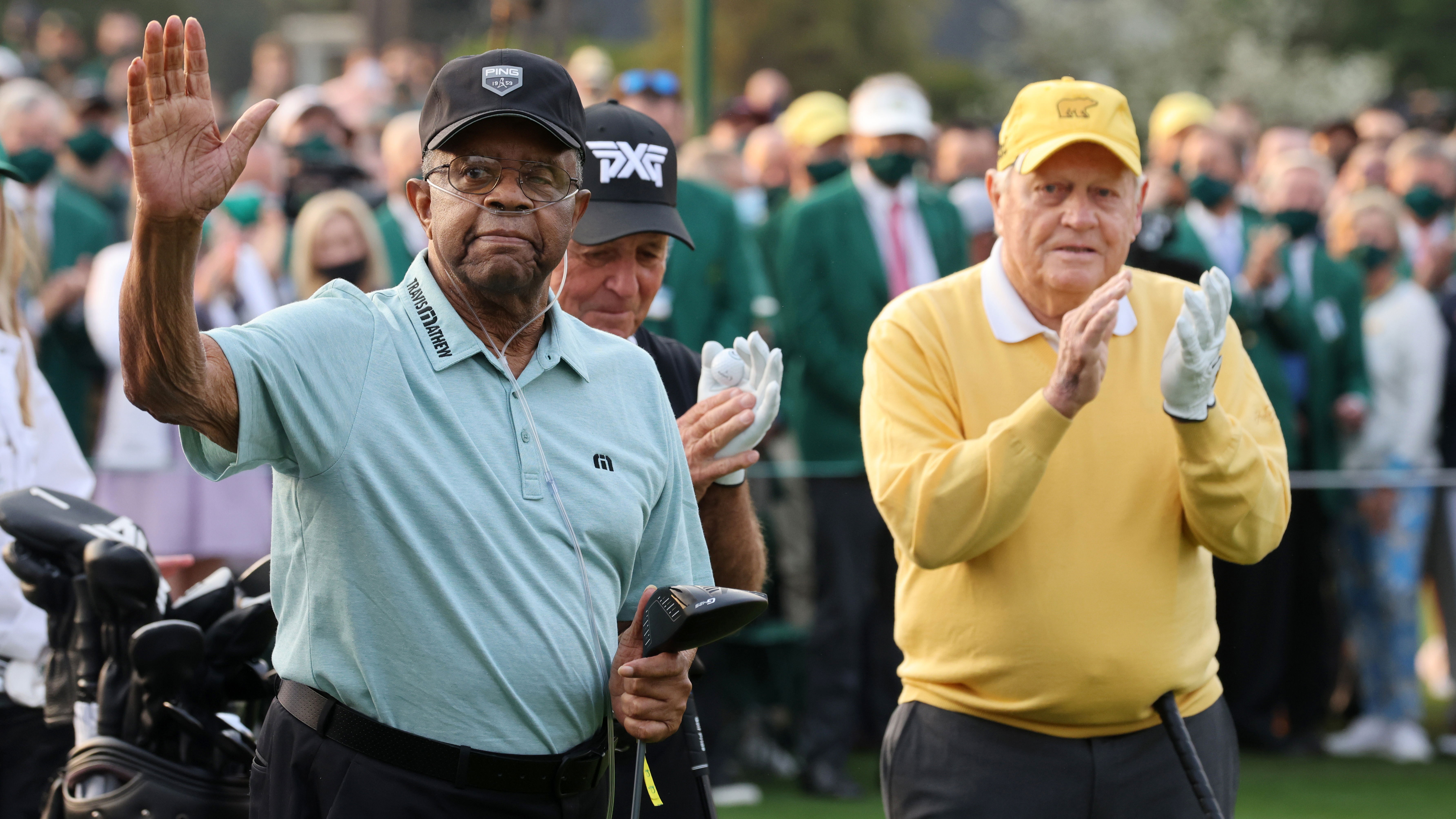 Gary Player's caddie "FLOGS GOLF BALLS" during Lee Elder's big Masters moment