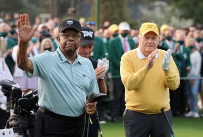 Gary Player's caddie "FLOGS GOLF BALLS" during Lee Elder's big Masters moment