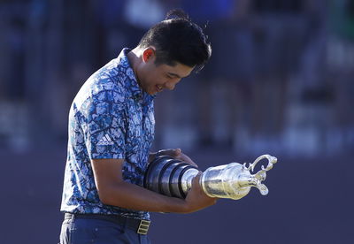 Open winner Collin Morikawa seen pulling CLARET JUG THROUGH AIRPORT on way home