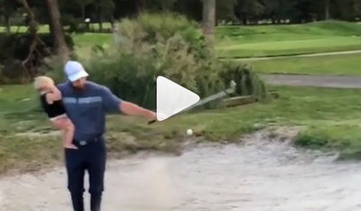 WATCH: Dad shows how to golf and parent at the same time!