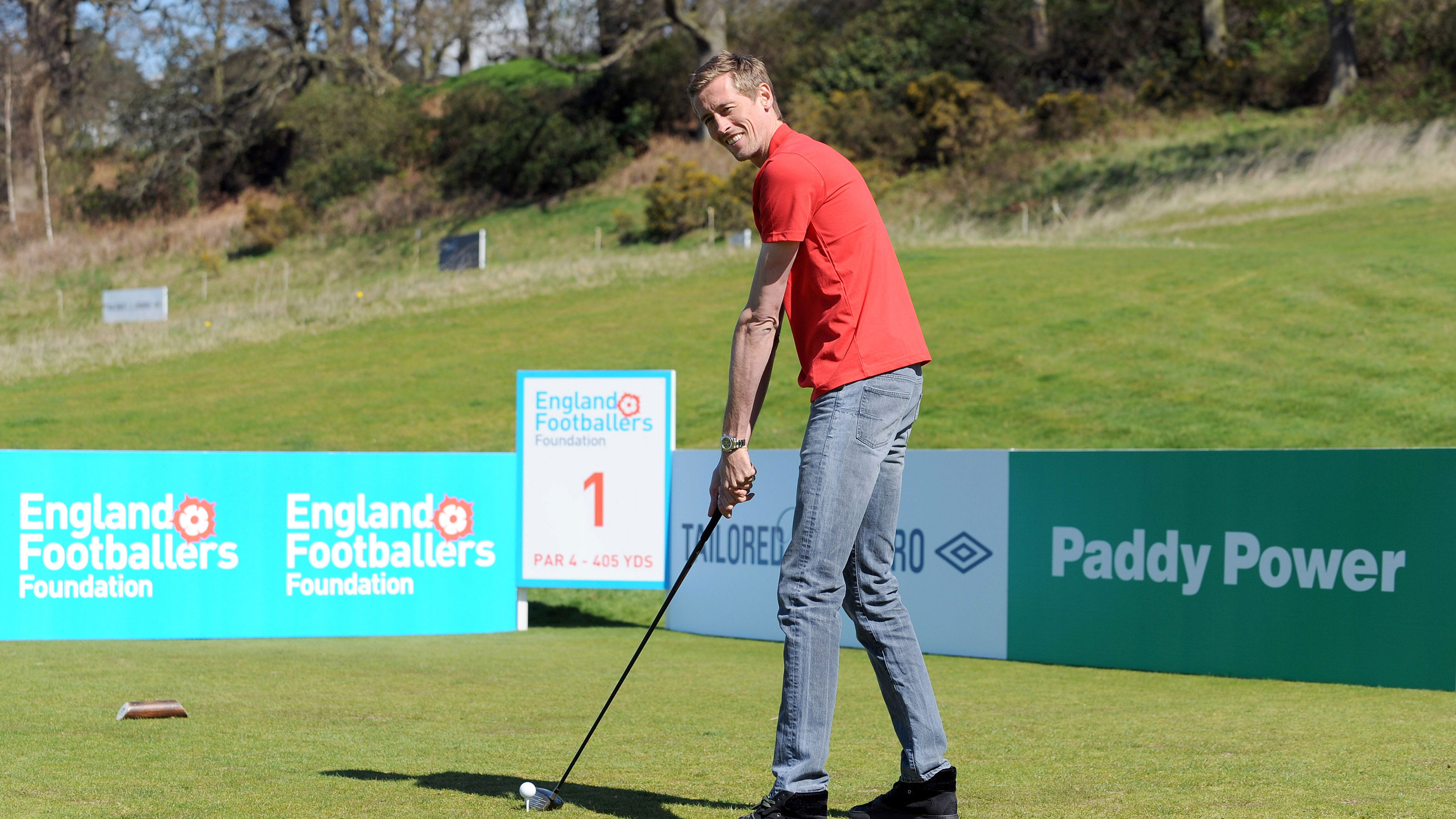 Why is the giant Peter Crouch using such small golf clubs?