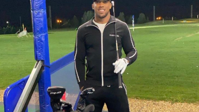 Social media reacts as Anthony Joshua plays golf with iron head covers!