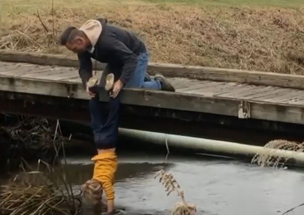 Social media reacts to dad holding son UPSIDE DOWN to collect golf balls