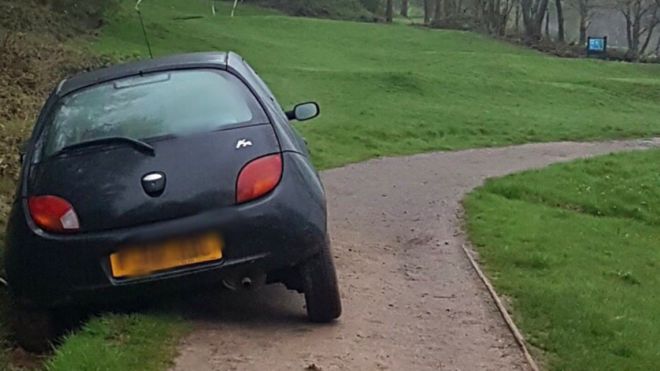 Young lady motorist drives into ditch at 11th hole, in a car!