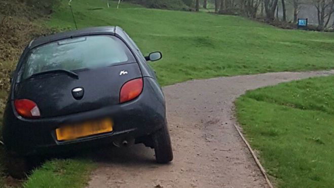 Young lady motorist drives into ditch at 11th hole, in a car!