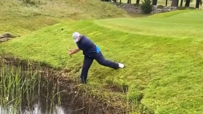 Golf caddie Billy Foster plays INSANE shot from out the water!