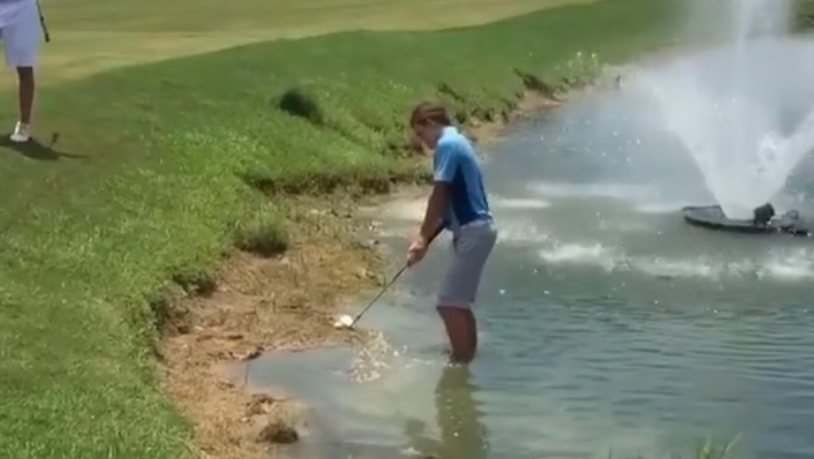 Golfer FALLS INTO LAKE after playing recovery shot!