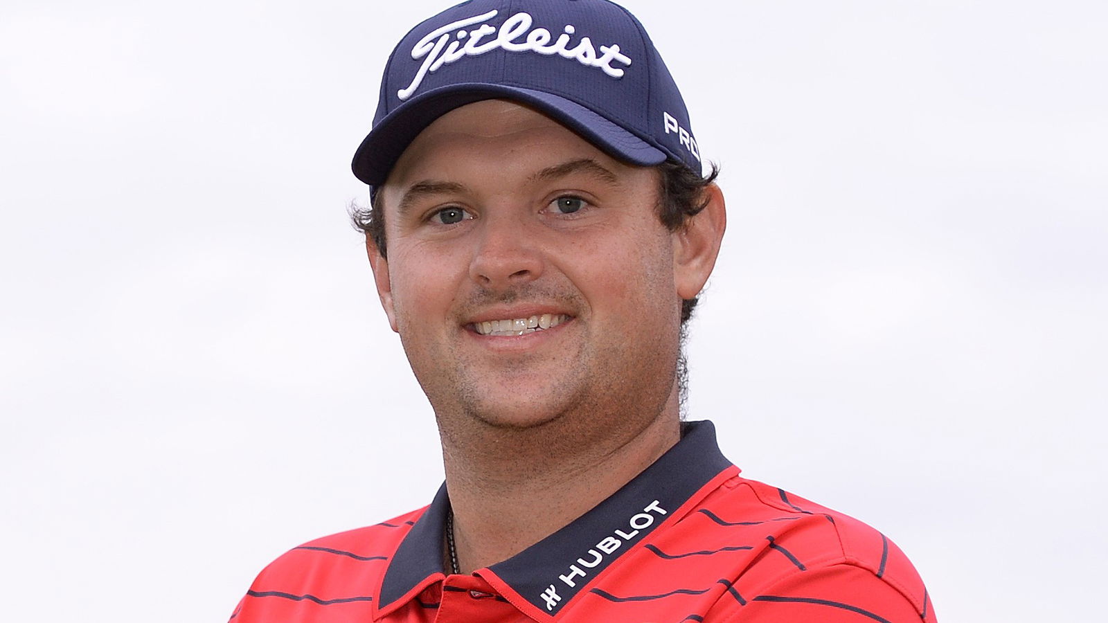 Why is Patrick Reed wearing a Titleist Cap on the PGA Tour and European Tour?