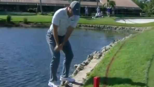 Rory McIlroy nearly falls in water, then plays shot out bush on knees!