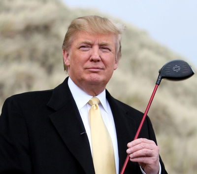 Donald Trump makes caddie hang on to back of golf cart!