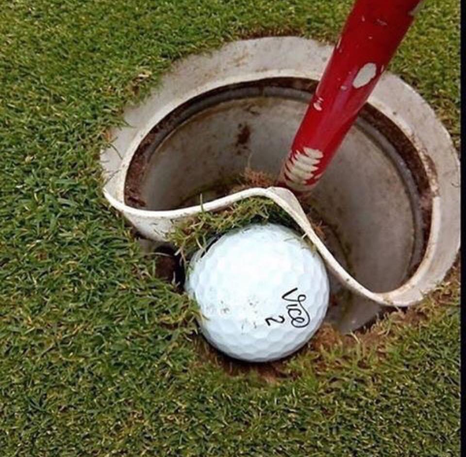 Ball embedded in the lip of the hole - what's the ruling? 