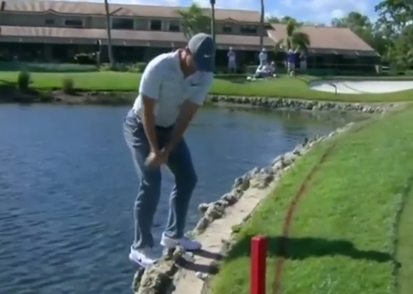 WATCH: Rory McIlroy nearly falls in water, then plays shot out bush on knees!