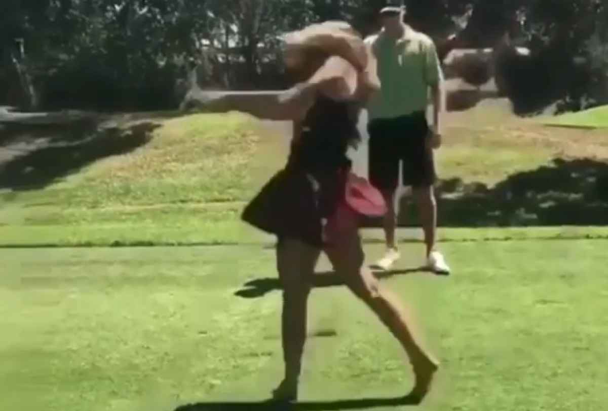 lady golfer hits golf shot then her skirt flies off