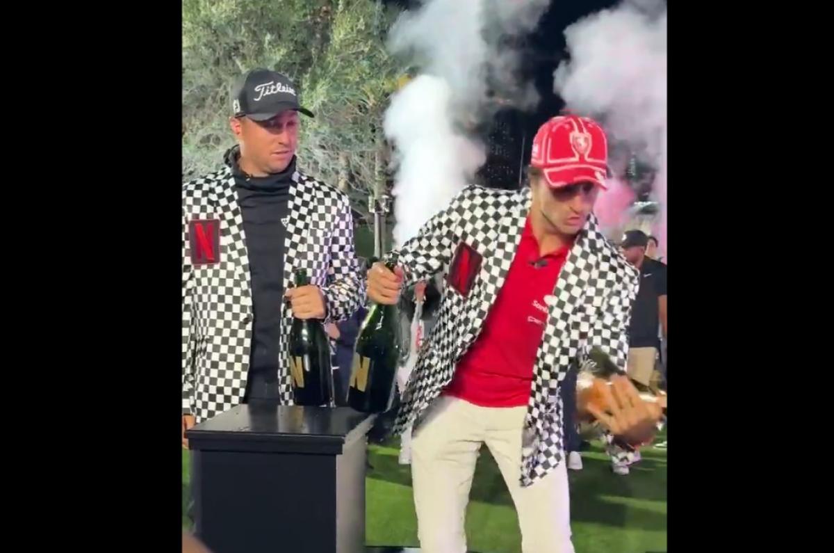 Carlos Sainz breaks the Netflix Cup in celebration with Justin Thomas