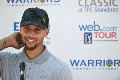 steph curry slam dunks opening tee shot into golf cart cup holder
