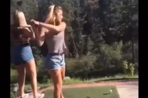 WATCH: Lady takes swing, misses ball and knocks out her best mate!