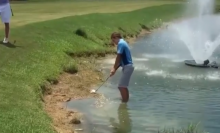 Golfer FALLS INTO LAKE after playing recovery shot!