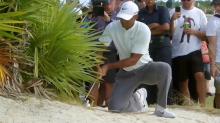 Tiger Woods says he double-hit golf shot but officials say no...