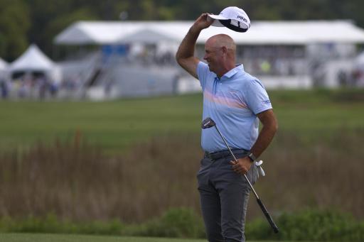 Stewart Cink throws his golf ball in celebration and hits spectator on the head