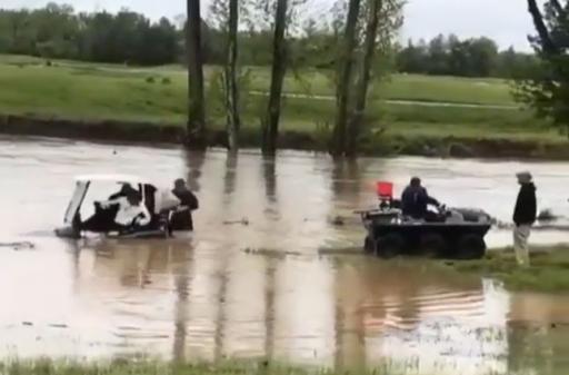Golfers dragged out of water whilst still in their golf cart