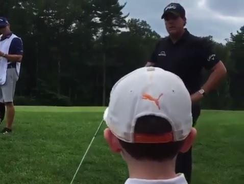 phil mickelson receives golf shot advice from little boy in crowd
