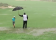 WATCH: Caddie protects young golfer from TORRENTIAL weather conditions