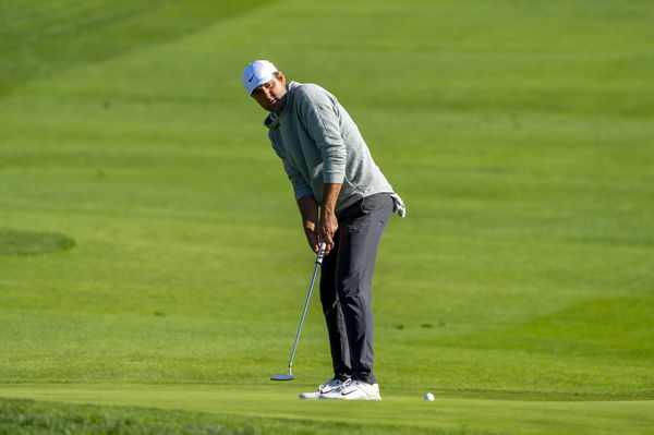 Scottie Scheffler putts golf ball into bunker at WM Phoenix Open